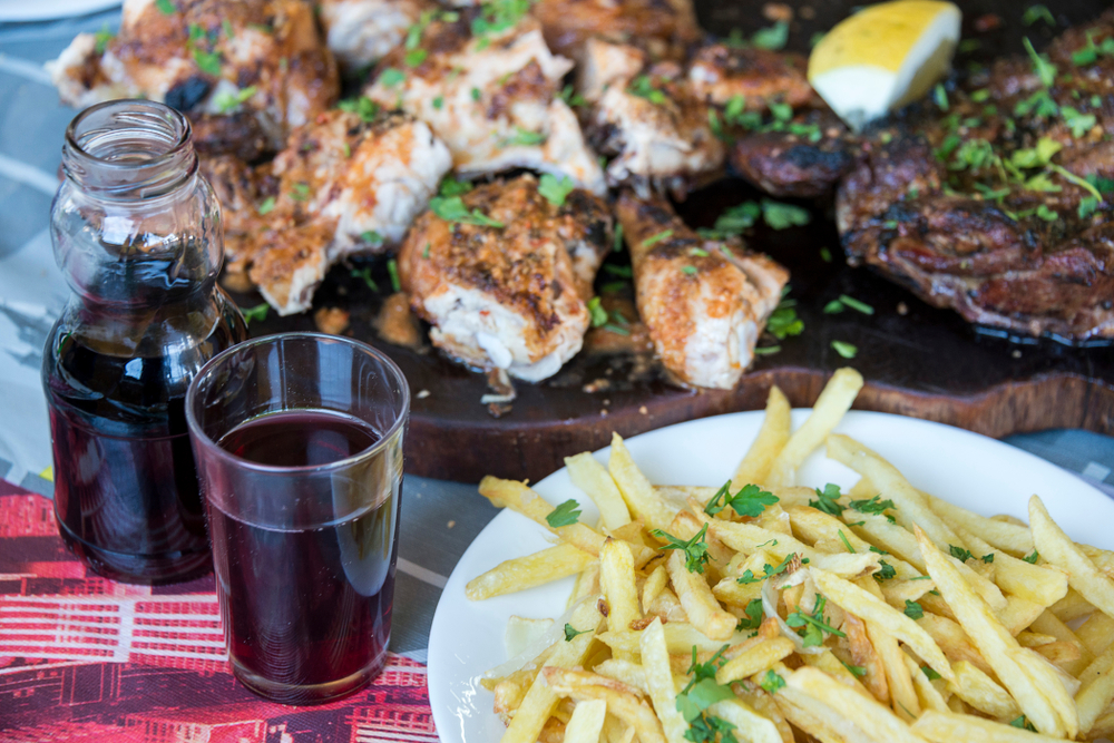 Grilled meat, local wine, and fries at a Canarian guachinche